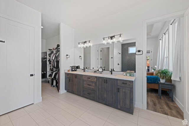 108 N Arrowhead Ln, Ivins, UT 84738 - ensuite bathroom featuring double vanity, tiled shower, and a walk in closet