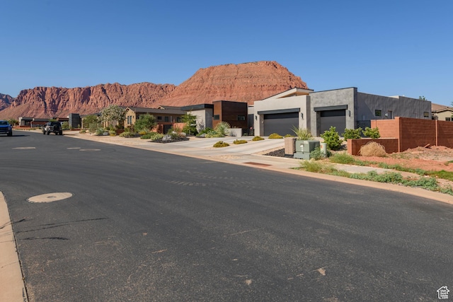 108 N Arrowhead Ln, Ivins, UT 84738 - view of front of home with a mountain view, driveway, a garage, and stucco siding
