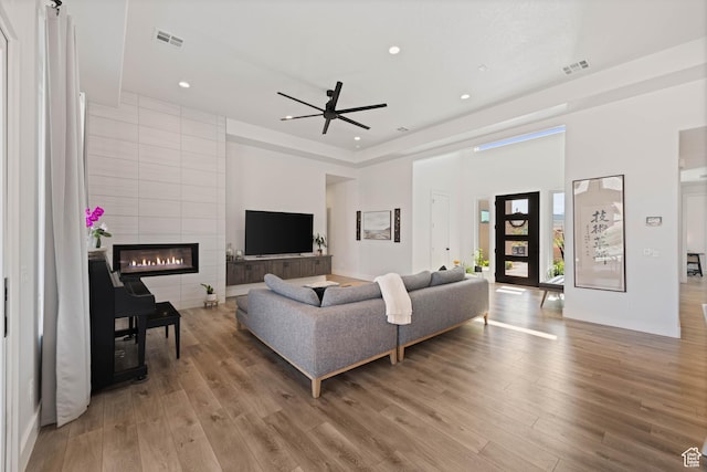 108 N Arrowhead Ln, Ivins, UT 84738 - living room featuring wood finished floors, recessed lighting, a tile fireplace, a towering ceiling, and ceiling fan