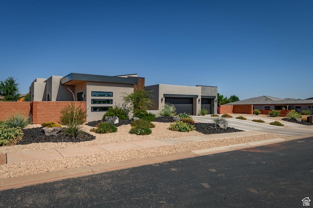 108 N Arrowhead Ln, Ivins, UT 84738 - contemporary house featuring stucco siding, an attached garage, and driveway
