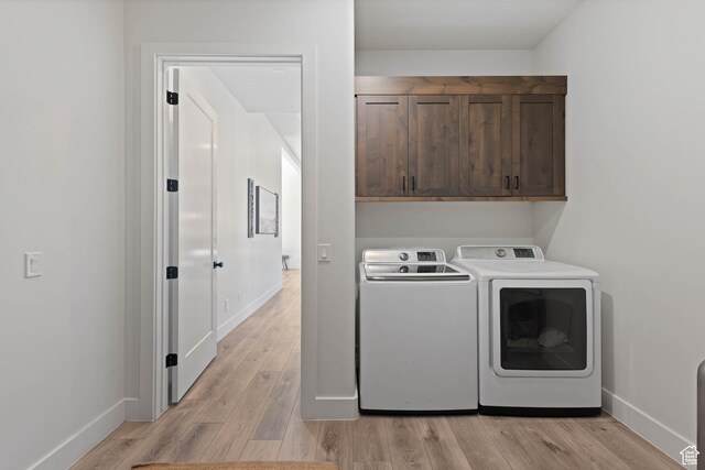108 N Arrowhead Ln, Ivins, UT 84738 - washroom with cabinet space, independent washer and dryer, light wood-style floors, and baseboards