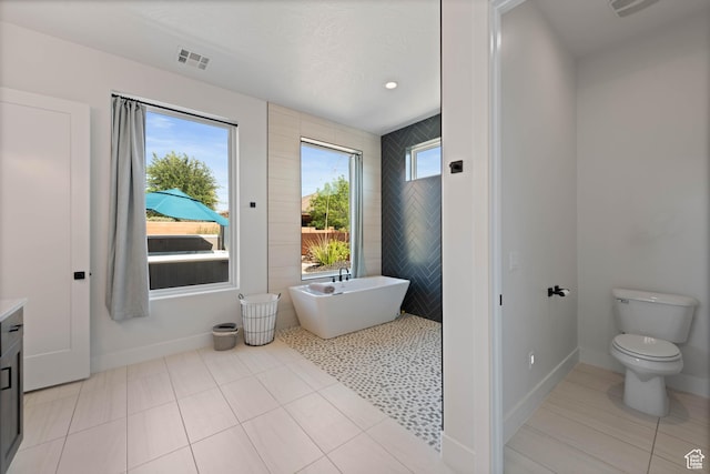 108 N Arrowhead Ln, Ivins, UT 84738 - full bathroom with toilet, a soaking tub, tile patterned floors, vanity, and baseboards