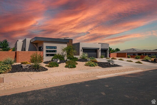 108 N Arrowhead Ln, Ivins, UT 84738 - modern home featuring stucco siding, an attached garage, and driveway