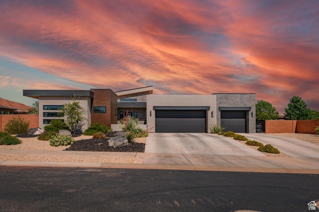 108 N Arrowhead Ln, Ivins, UT 84738 - contemporary home featuring an attached garage, driveway, and stucco siding
