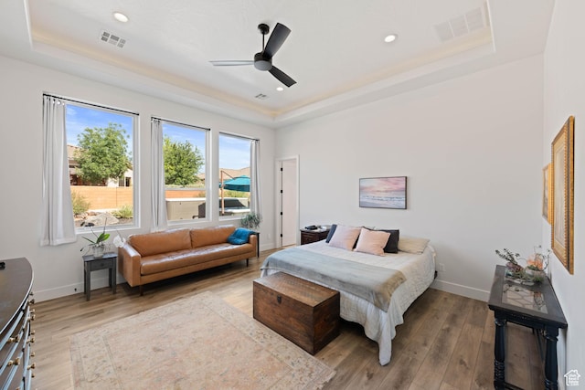 108 N Arrowhead Ln, Ivins, UT 84738 - bedroom featuring a tray ceiling, wood finished floors, baseboards, a ceiling fan, and recessed lighting