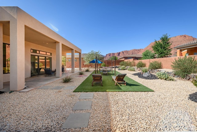 108 N Arrowhead Ln, Ivins, UT 84738 - fenced backyard with a mountain view and a patio