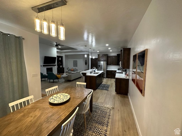 2786 S 3780 W, Hurricane, UT 84737 - dining space with light wood-type flooring, baseboards, a fireplace, ceiling fan, and recessed lighting