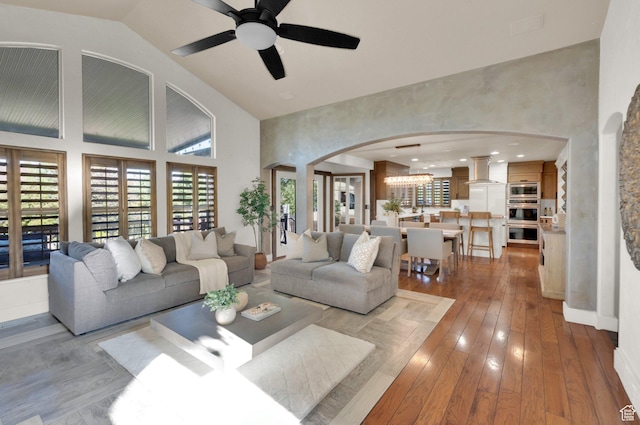 4836 S 5050 W, Hooper, UT 84315 - living room with high vaulted ceiling, arched walkways, a ceiling fan, and hardwood / wood-style floors