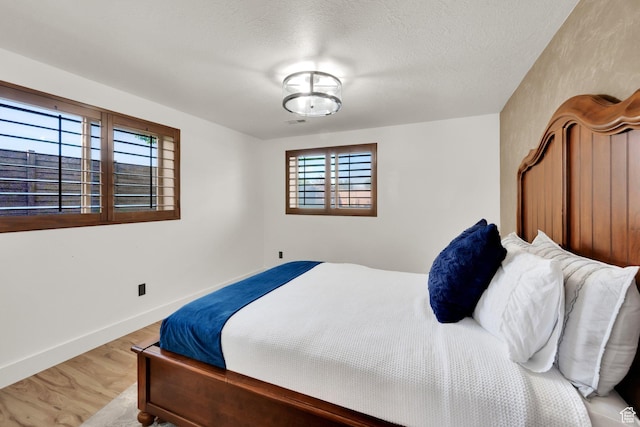 4836 S 5050 W, Hooper, UT 84315 - bedroom with wood finished floors, baseboards, and a textured ceiling