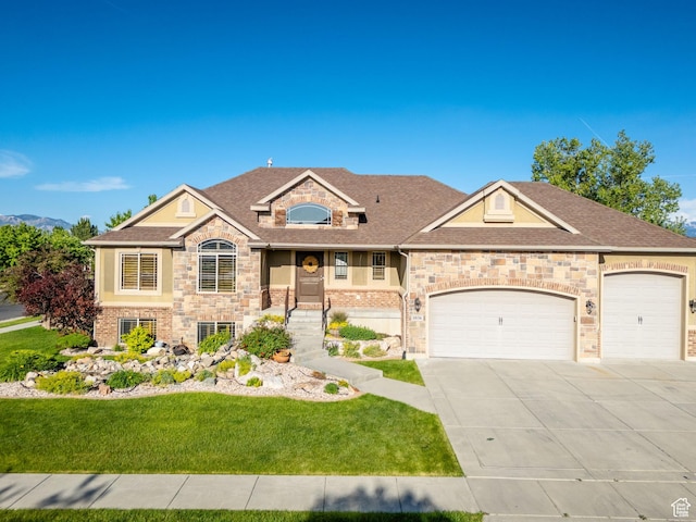 4836 S 5050 W, Hooper, UT 84315 - view of front of house with concrete driveway, a front yard, a garage, stone siding, and roof with shingles