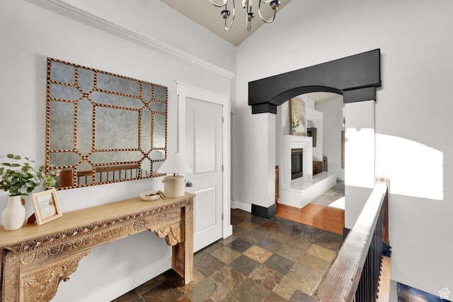 4836 S 5050 W, Hooper, UT 84315 - hallway with dark stone finish floors, a chandelier, arched walkways, and baseboards
