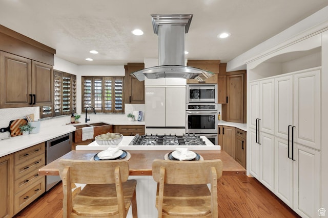 4836 S 5050 W, Hooper, UT 84315 - kitchen featuring built in appliances, a sink, island exhaust hood, tasteful backsplash, and recessed lighting