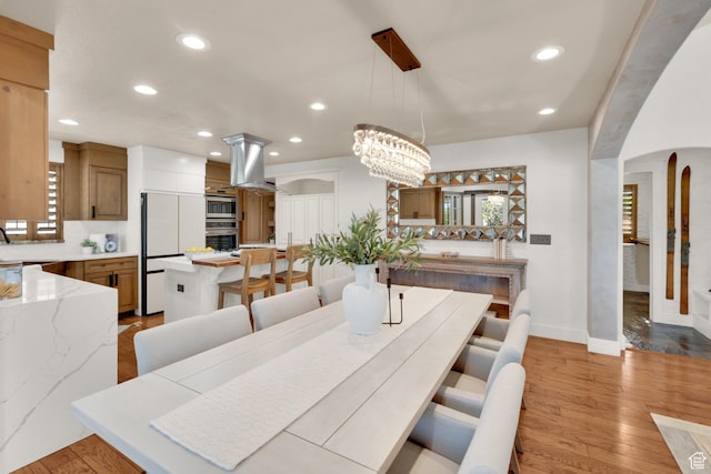 4836 S 5050 W, Hooper, UT 84315 - dining room featuring recessed lighting, light wood-style floors, arched walkways, baseboards, and a chandelier