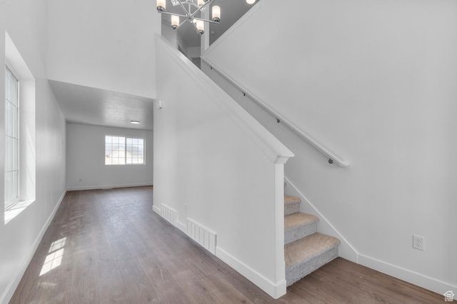 6747 N Tulle Mtn, Eagle Mountain, UT 84005 - staircase with wood finished floors, baseboards, a chandelier, and a high ceiling