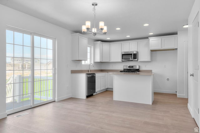 6747 N Tulle Mtn, Eagle Mountain, UT 84005 - kitchen featuring stainless steel appliances, baseboards, recessed lighting, a chandelier, and a sink