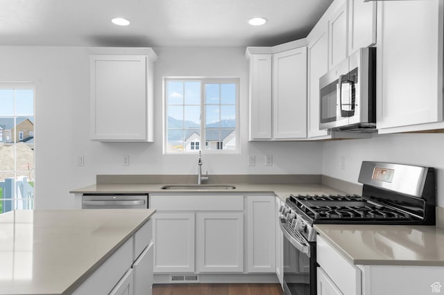 6747 N Tulle Mtn, Eagle Mountain, UT 84005 - kitchen featuring appliances with stainless steel finishes, a sink, white cabinetry, healthy amount of natural light, and recessed lighting