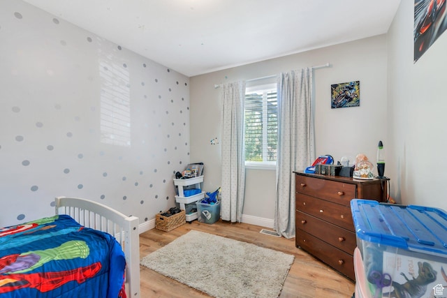 7371 N Ute Dr, Eagle Mountain, UT 84005 - bedroom featuring light wood-style floors and baseboards