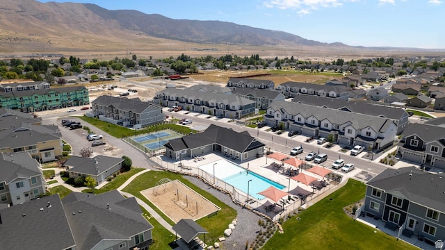 1764 E Fall St, Eagle Mountain, UT 84005 - aerial perspective of suburban area with a pool area and a mountain backdrop