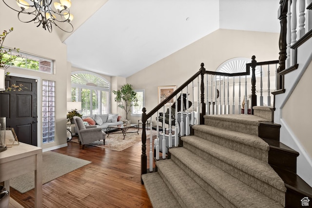 4601 S Farm Meadow Ln, Millcreek, UT 84117 - foyer entrance with high vaulted ceiling, stairway, a chandelier, and dark wood-type flooring