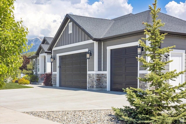 2548 E Ember Dr, Draper Ut Cnty, UT 84020 - view of side of property with a garage, board and batten siding, roof with shingles, concrete driveway, and stone siding