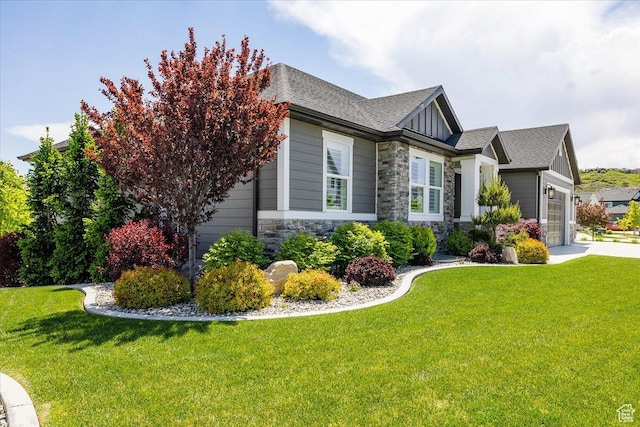 2548 E Ember Dr, Draper Ut Cnty, UT 84020 - view of side of home featuring stone siding, a garage, a yard, and a shingled roof