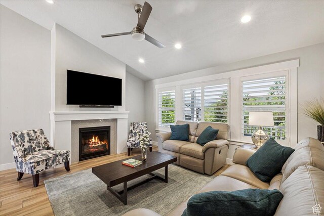 2548 E Ember Dr, Draper Ut Cnty, UT 84020 - living area with light wood finished floors, vaulted ceiling, ceiling fan, recessed lighting, and a glass covered fireplace
