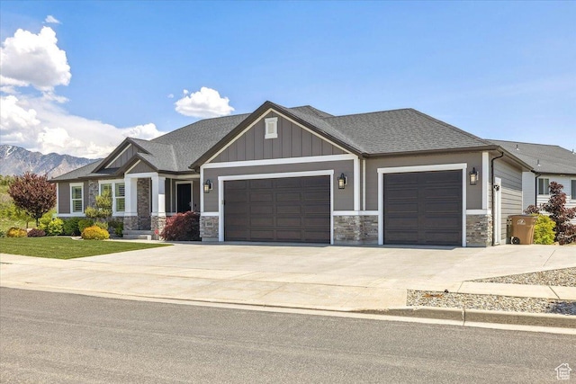 2548 E Ember Dr, Draper Ut Cnty, UT 84020 - craftsman inspired home with an attached garage, concrete driveway, stone siding, board and batten siding, and a mountain view
