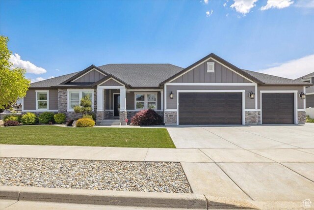 2548 E Ember Dr, Draper Ut Cnty, UT 84020 - craftsman inspired home with an attached garage, stone siding, a front yard, concrete driveway, and board and batten siding