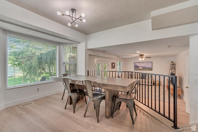 2761 W 9800 S, South Jordan, UT 84095 - dining room with healthy amount of natural light, a chandelier, baseboards, light wood-style floors, and a textured ceiling