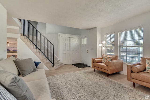2761 W 9800 S, South Jordan, UT 84095 - living area with wood finished floors, stairway, a textured ceiling, and baseboards