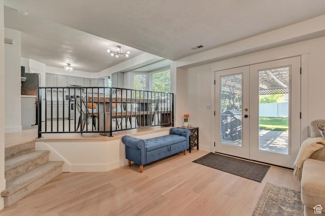 2761 W 9800 S, South Jordan, UT 84095 - entrance foyer with light wood-type flooring, french doors, a chandelier, and stairs