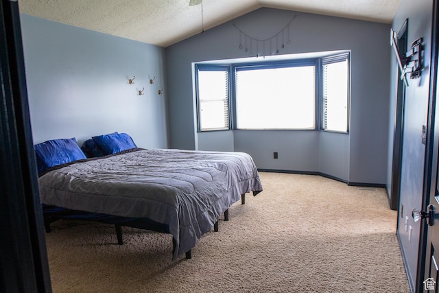 2182 W 1145 N, Clinton, UT 84015 - bedroom featuring light colored carpet, vaulted ceiling, a textured ceiling, and baseboards