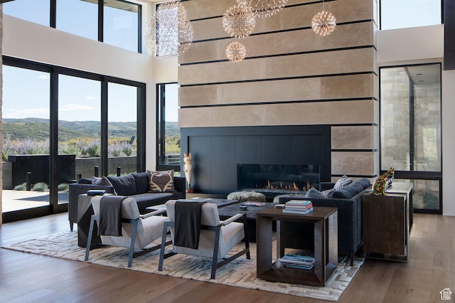 7744 E Moon Dance Cir, Kamas, UT 84036 - living area with a chandelier, a towering ceiling, wood finished floors, healthy amount of natural light, and a mountain view