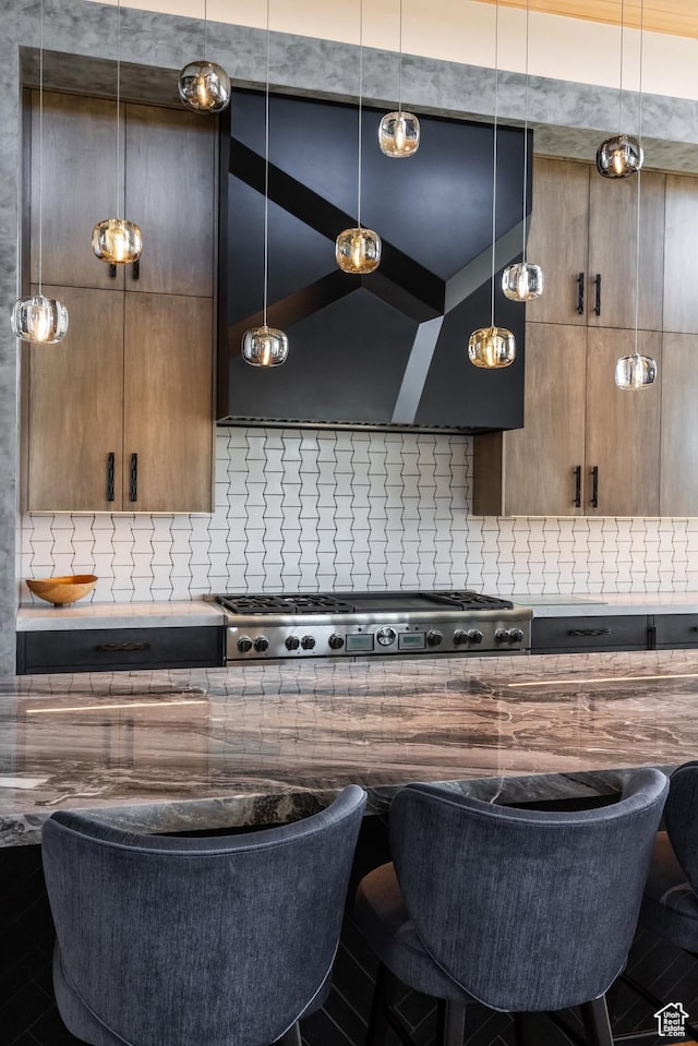 7744 E Moon Dance Cir, Kamas, UT 84036 - kitchen featuring backsplash, exhaust hood, cooktop, and a kitchen breakfast bar