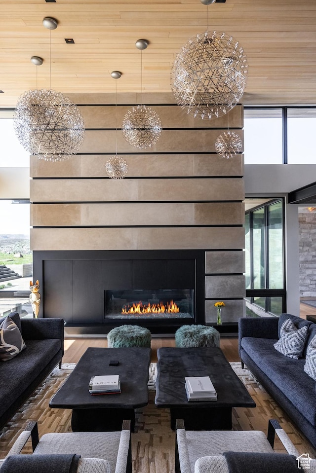 7744 E Moon Dance Cir, Kamas, UT 84036 - living room with plenty of natural light, a glass covered fireplace, and wood finished floors