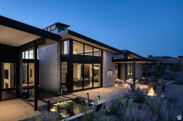 7744 E Moon Dance Cir, Kamas, UT 84036 - rear view of house with an outdoor fire pit and a patio area