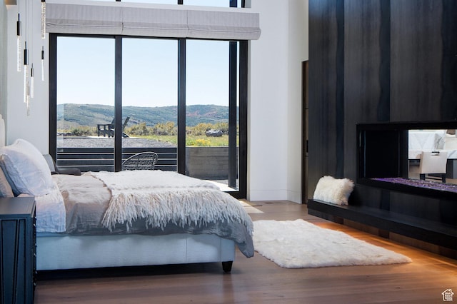 7744 E Moon Dance Cir, Kamas, UT 84036 - bedroom with wood finished floors and a mountain view