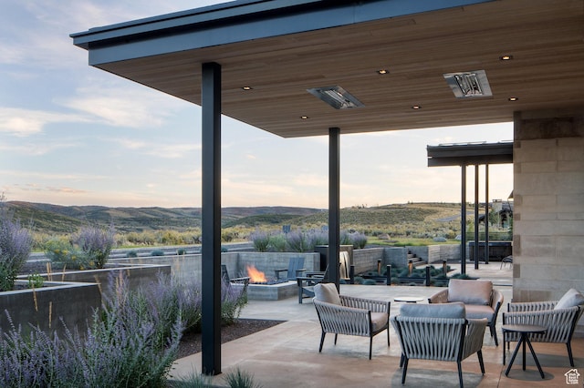 7744 E Moon Dance Cir, Kamas, UT 84036 - view of patio with an outdoor fire pit and a mountain view