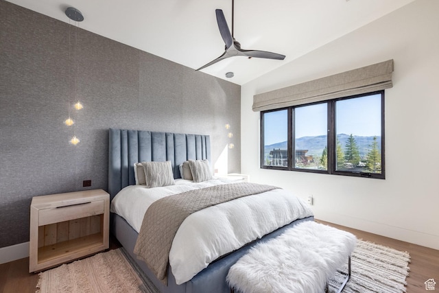 7744 E Moon Dance Cir, Kamas, UT 84036 - bedroom featuring wood finished floors, lofted ceiling, a ceiling fan, and baseboards