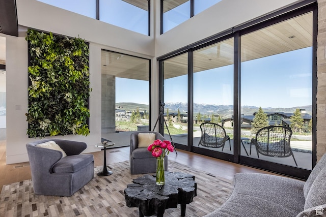 7744 E Moon Dance Cir, Kamas, UT 84036 - living area with a mountain view, wood finished floors, floor to ceiling windows, and a towering ceiling