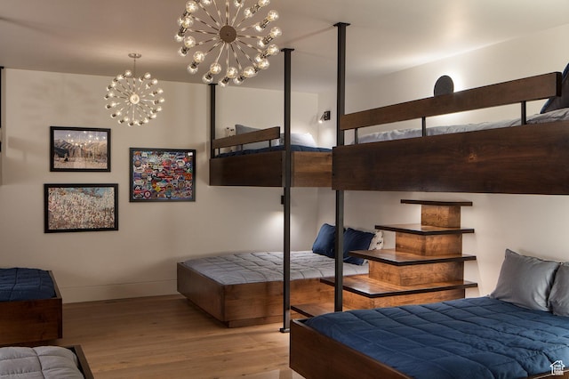 7744 E Moon Dance Cir, Kamas, UT 84036 - bedroom featuring wood finished floors, a chandelier, and baseboards