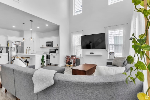 1994 N 3900 W Unit 217, Lehi, UT 84043 - living room featuring light wood finished floors, plenty of natural light, recessed lighting, and a towering ceiling
