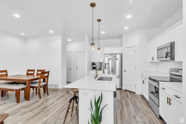 1994 N 3900 W Unit 217, Lehi, UT 84043 - kitchen featuring stainless steel appliances, a sink, light wood finished floors, a breakfast bar area, and recessed lighting