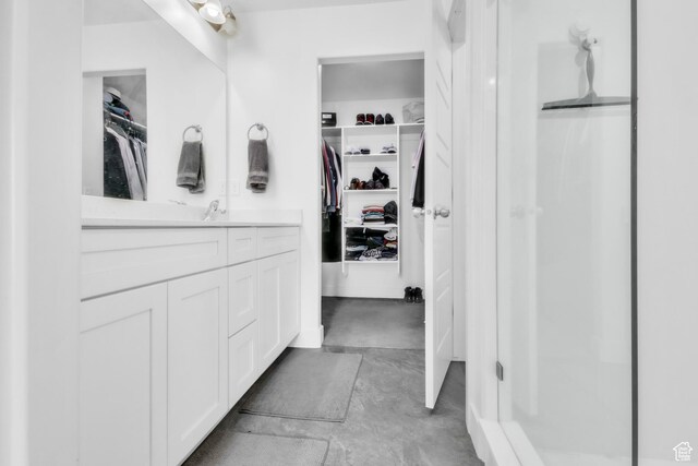 1994 N 3900 W Unit 217, Lehi, UT 84043 - bathroom featuring vanity, a spacious closet, a shower stall, and concrete flooring