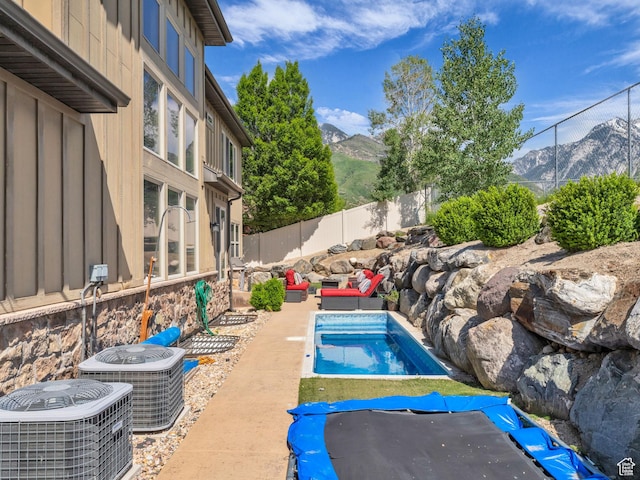 2894 E Cobblemoor Ln, Sandy, UT 84093 - view of swimming pool featuring cooling unit, a mountain view, a fenced backyard, and an outdoor living space