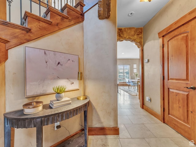 2894 E Cobblemoor Ln, Sandy, UT 84093 - corridor with light tile patterned floors, arched walkways, and baseboards