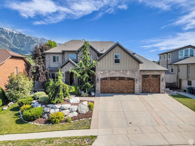 2894 E Cobblemoor Ln, Sandy, UT 84093 - craftsman-style house featuring board and batten siding, concrete driveway, stone siding, an attached garage, and a mountain view