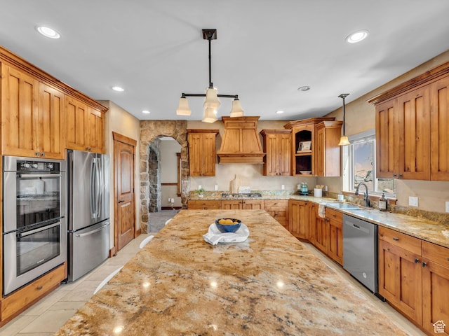 2894 E Cobblemoor Ln, Sandy, UT 84093 - kitchen featuring appliances with stainless steel finishes, custom exhaust hood, light stone counters, recessed lighting, and a sink