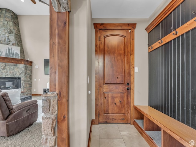 2894 E Cobblemoor Ln, Sandy, UT 84093 - mudroom with light tile patterned flooring, a fireplace, and baseboards