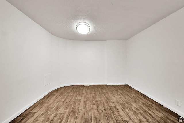10679 S 2200 W, South Jordan, UT 84095 - empty room with wood finished floors, baseboards, and a textured ceiling